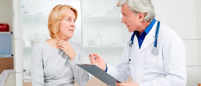 Mulher com dor de garganta conversando com o médico - coronavírus